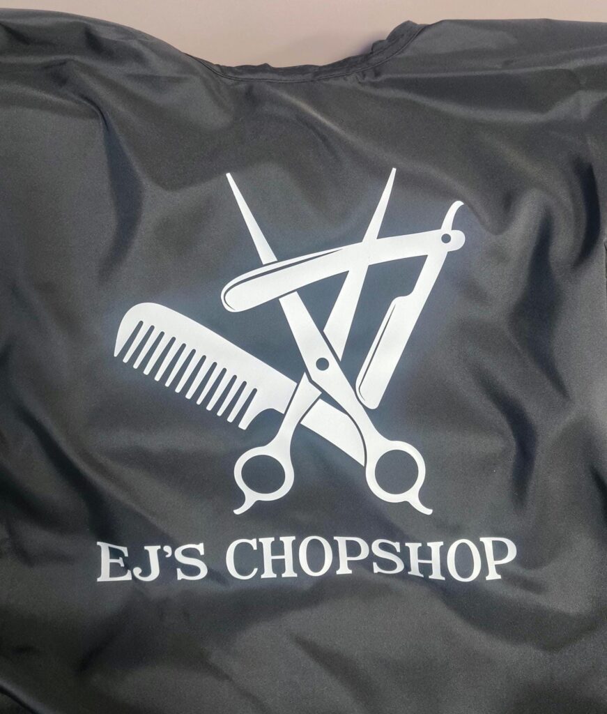 Hair Salon & Barber Cape with Pre-Designed Logo. Customizable Text for a Unique, Branded Look for Professional Stylists and Barbers.