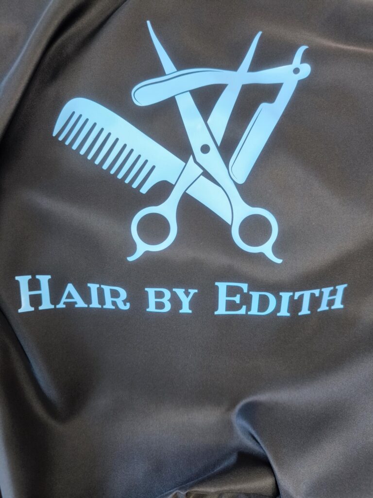Hair Salon & Barber Cape with Pre-Designed Logo. Customizable Text for a Unique, Branded Look for Professional Stylists and Barbers.