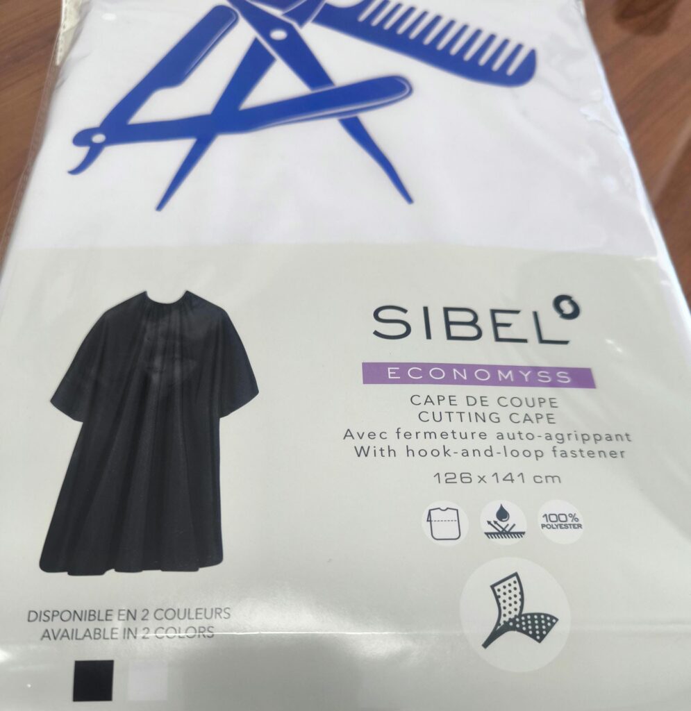 Hair Salon & Barber Cape with Pre-Designed Logo. Customizable Text for a Unique, Branded Look for Professional Stylists and Barbers.